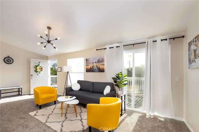 carpeted living room featuring baseboards and a chandelier