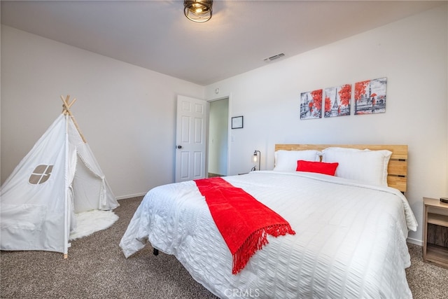 carpeted bedroom with visible vents and baseboards
