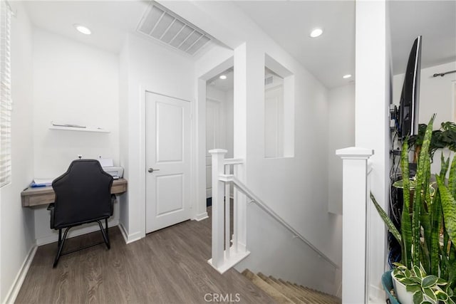 corridor featuring wood finished floors, visible vents, an upstairs landing, and recessed lighting