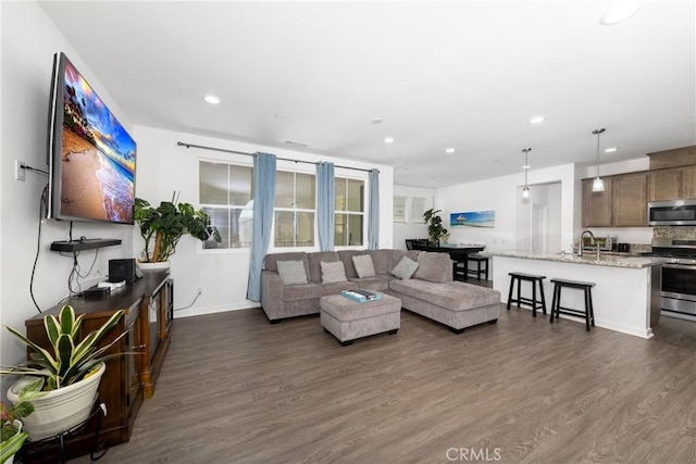 living room featuring recessed lighting, dark wood-type flooring, and baseboards