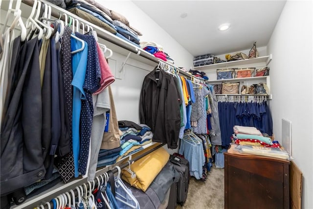 walk in closet with carpet flooring