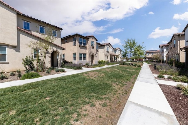 view of community featuring a yard and a residential view