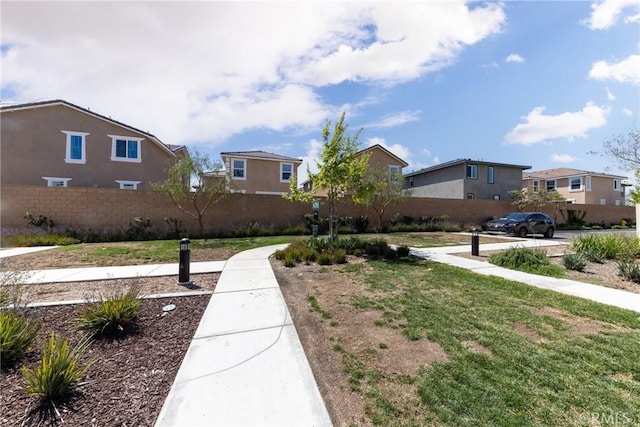 view of yard with a residential view and fence
