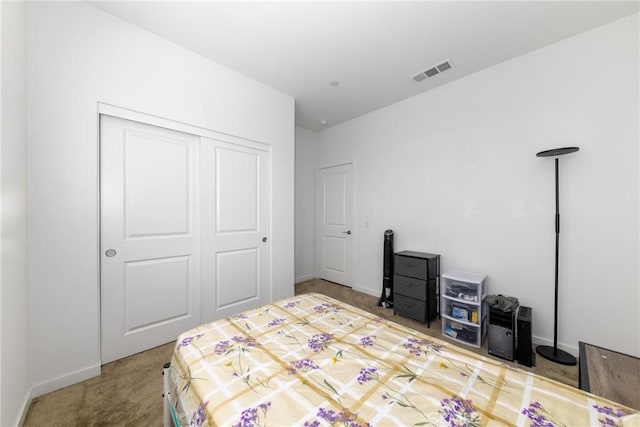 bedroom featuring visible vents, baseboards, a closet, and carpet floors