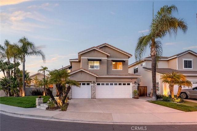traditional-style home featuring a garage, stucco siding, stone siding, a tile roof, and concrete driveway