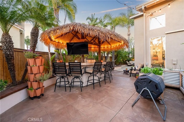 view of patio / terrace with outdoor dry bar and fence