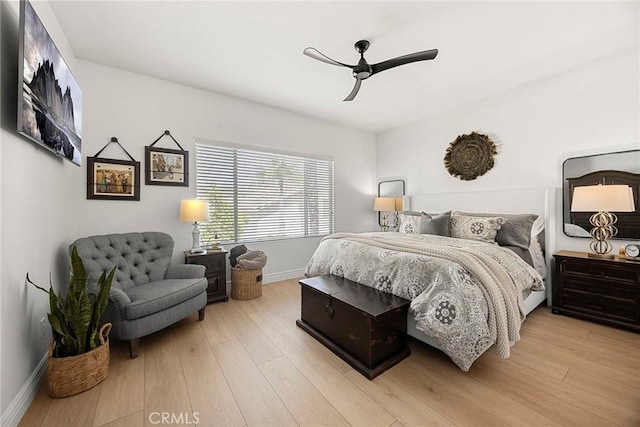bedroom featuring baseboards, a ceiling fan, and wood finished floors