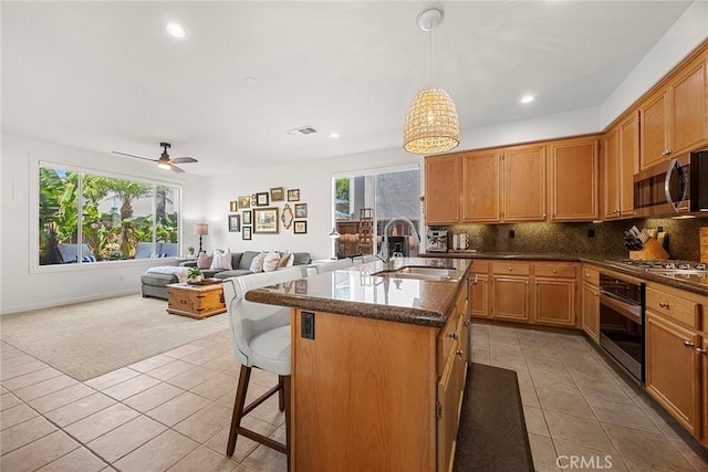 kitchen featuring stainless steel appliances, a wealth of natural light, light tile patterned floors, and visible vents
