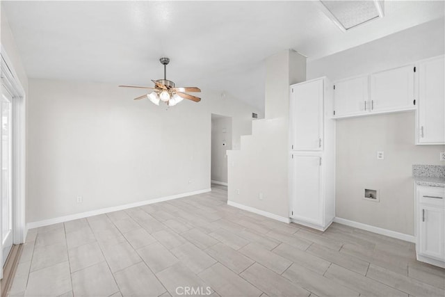 kitchen with white cabinetry, baseboards, and a ceiling fan