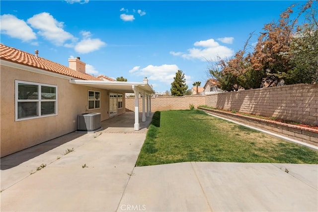 view of yard featuring a fenced backyard, cooling unit, and a patio