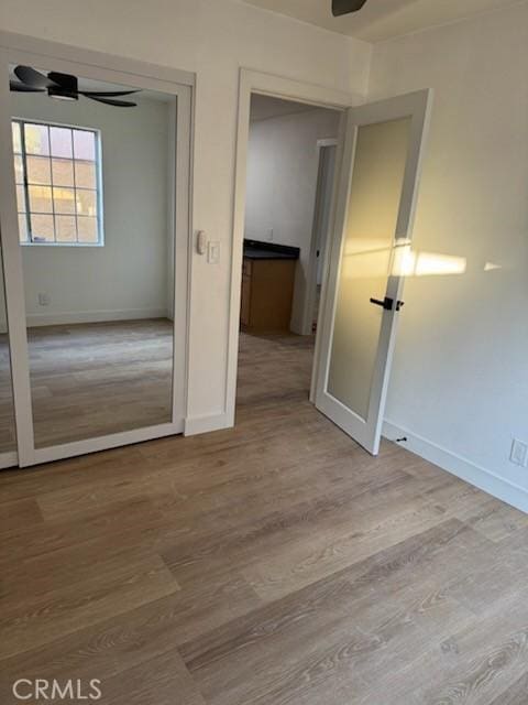 unfurnished bedroom featuring baseboards and wood finished floors