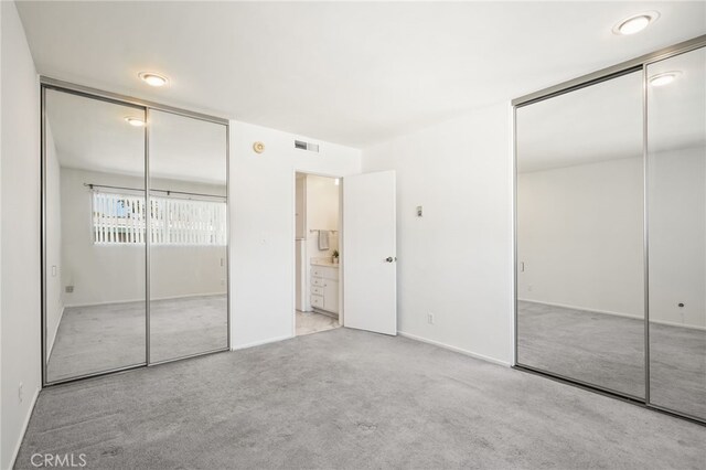 10240 Camarillo St Unit 204, Toluca Lake, CA 91602 - unfurnished bedroom featuring two closets, visible vents, and carpet