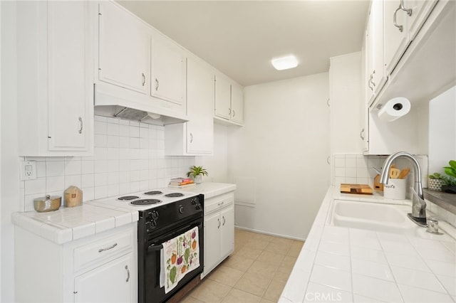 10240 Camarillo St Unit 204, Toluca Lake, CA 91602 - kitchen featuring a sink, black / electric stove, tile countertops, and tasteful backsplash