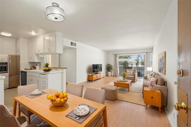 10240 Camarillo St Unit 204, Toluca Lake, CA 91602 - dining room featuring light wood-type flooring and visible vents