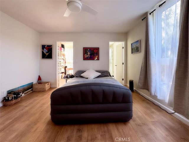 bedroom with light wood-style floors and a ceiling fan