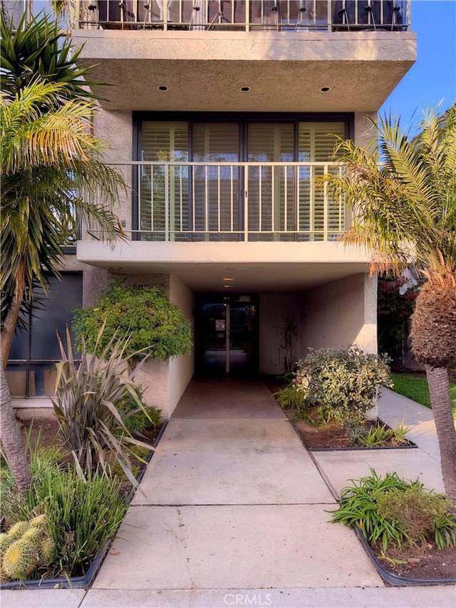view of property featuring driveway and a carport