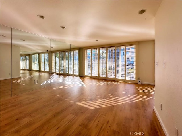 spare room with wood finished floors and baseboards