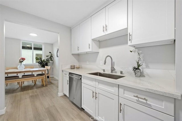 9950 Durant Dr Unit 208, Beverly Hills, CA 90212 - kitchen with stainless steel dishwasher, a sink, white cabinetry, light wood-type flooring, and baseboards