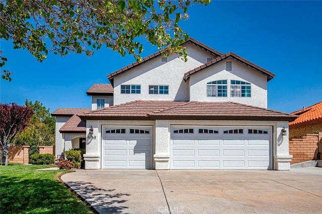 view of front of property featuring stucco siding, concrete driveway, a garage, and a front lawn
