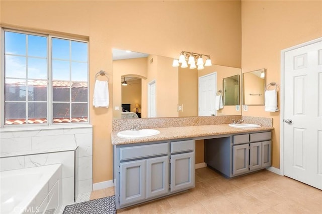 bathroom with a sink, tile patterned floors, double vanity, and connected bathroom