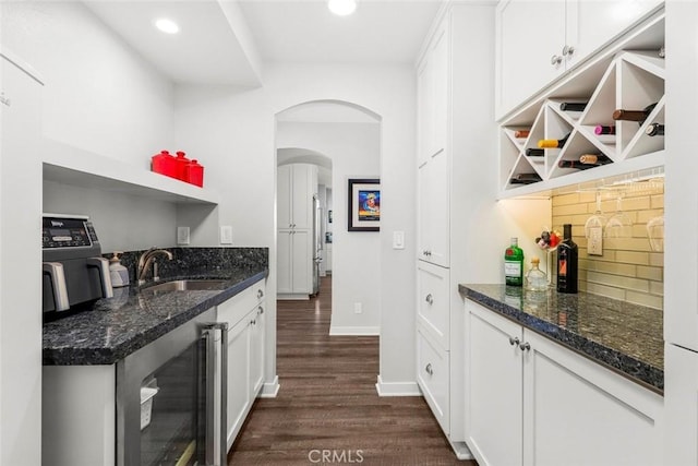 kitchen with tasteful backsplash, white cabinetry, open shelves, dark wood finished floors, and beverage cooler