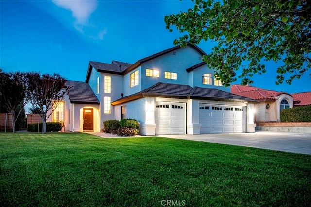 traditional home with a front yard, driveway, and stucco siding