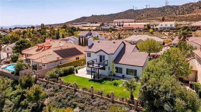 birds eye view of property with a mountain view and a residential view
