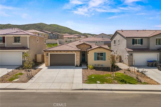 view of front of home with a mountain view, a residential view, a tiled roof, stucco siding, and driveway