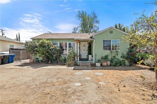 ranch-style house with fence and stucco siding