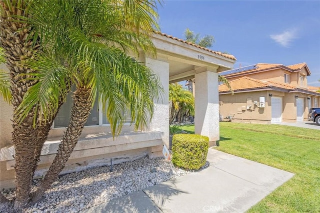 3594 N Verbena, Rialto, CA 92377 - view of property exterior featuring a lawn, stucco siding, and a tile roof