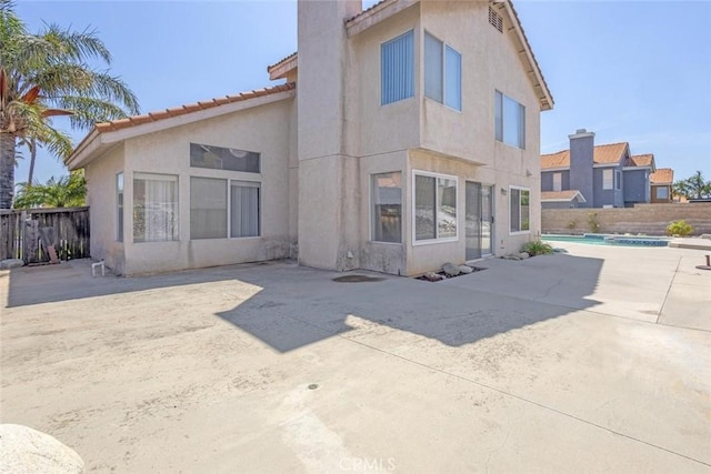 3594 N Verbena, Rialto, CA 92377 - back of property with stucco siding, a patio area, a fenced backyard, a tiled roof, and a chimney