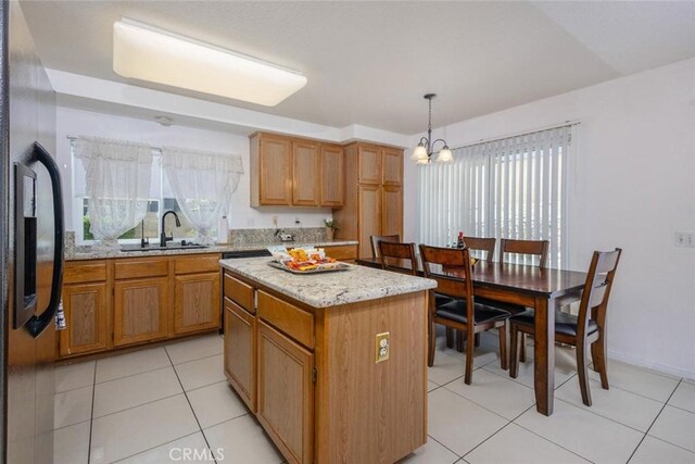 3594 N Verbena, Rialto, CA 92377 - kitchen with a chandelier, a kitchen island, light tile patterned floors, decorative light fixtures, and light stone counters