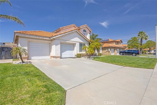 3594 N Verbena, Rialto, CA 92377 - mediterranean / spanish home featuring a tile roof, stucco siding, driveway, an attached garage, and a front yard