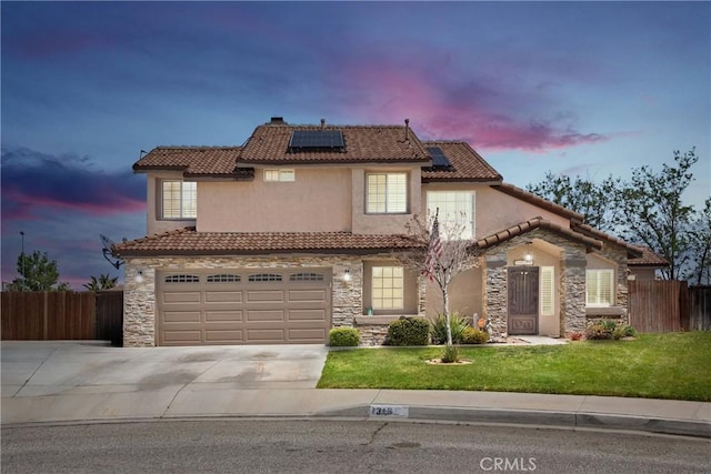 traditional-style house with a tile roof, fence, stone siding, and driveway
