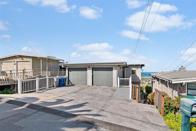 view of front facade with a detached garage and fence