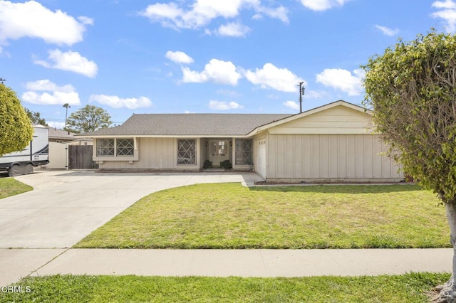single story home with a front lawn and concrete driveway