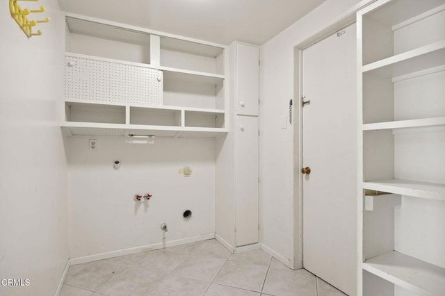clothes washing area with tile patterned floors, electric dryer hookup, laundry area, and hookup for a gas dryer