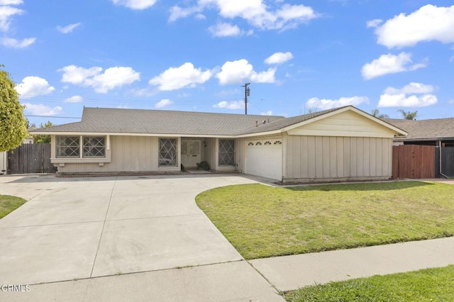 ranch-style home featuring a front lawn, driveway, an attached garage, and fence