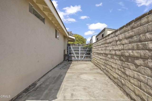 view of property exterior featuring fence, a patio, and stucco siding