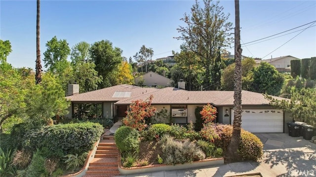 1460 E Glenoaks Blvd, Glendale, CA 91206 - view of front of home with a chimney, a garage, concrete driveway, and stairway