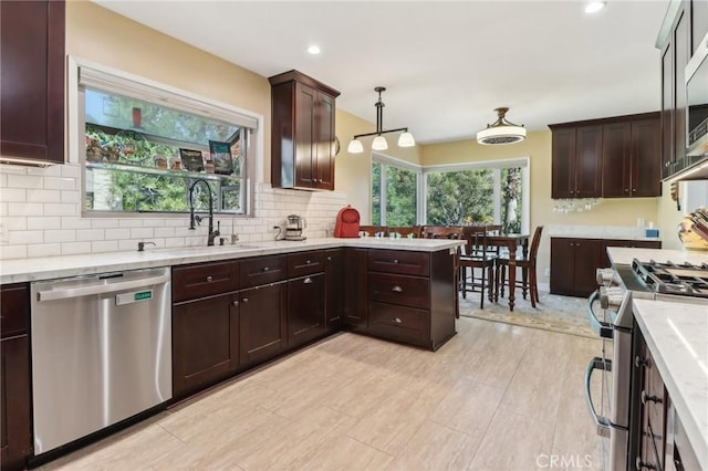 1460 E Glenoaks Blvd, Glendale, CA 91206 - kitchen with appliances with stainless steel finishes, a sink, decorative backsplash, dark brown cabinets, and pendant lighting