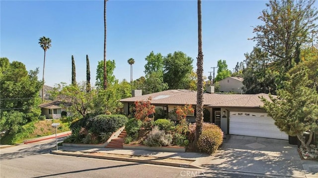 1460 E Glenoaks Blvd, Glendale, CA 91206 - view of front of property with a garage, concrete driveway, and a chimney