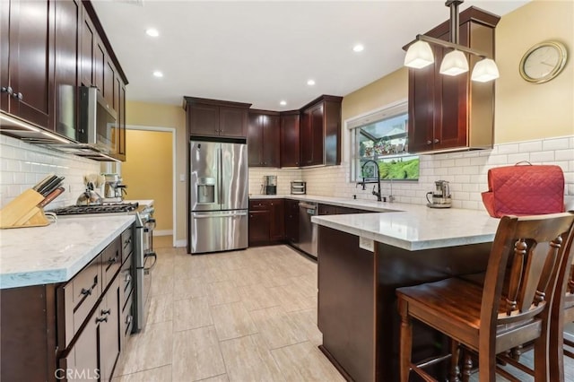 1460 E Glenoaks Blvd, Glendale, CA 91206 - kitchen featuring stainless steel appliances, a peninsula, tasteful backsplash, a kitchen breakfast bar, and recessed lighting