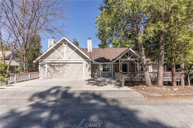 381 Old Toll Rd, Lake Arrowhead, CA 92317 - view of front facade featuring concrete driveway, a porch, a chimney, and an attached garage