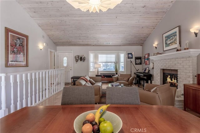 381 Old Toll Rd, Lake Arrowhead, CA 92317 - dining room with visible vents, a fireplace, vaulted ceiling, and wood ceiling
