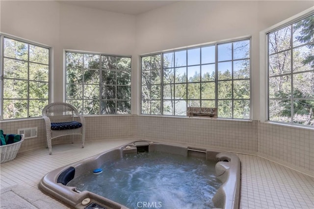 381 Old Toll Rd, Lake Arrowhead, CA 92317 - unfurnished sunroom featuring visible vents and a hot tub