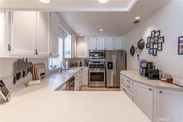 381 Old Toll Rd, Lake Arrowhead, CA 92317 - kitchen with stainless steel appliances, white cabinets, light countertops, and a sink