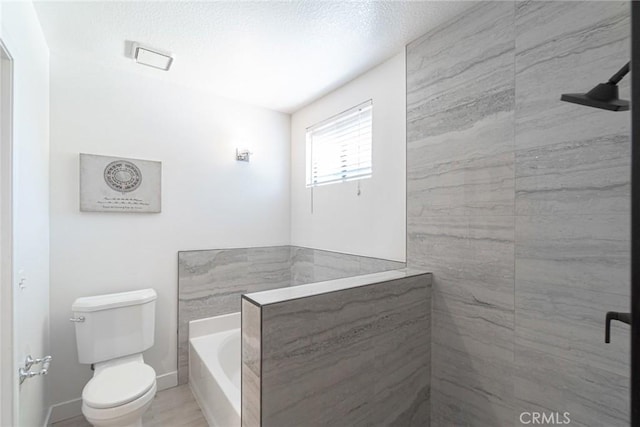full bathroom with toilet, a garden tub, and baseboards