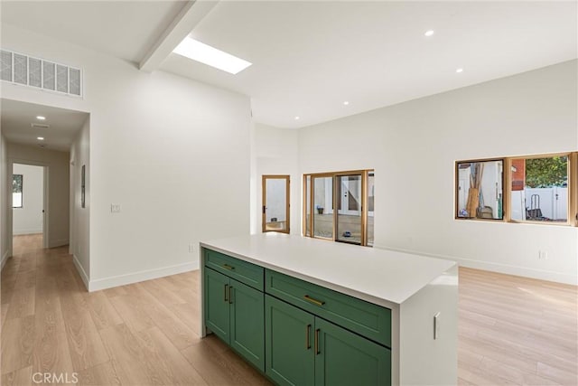 kitchen featuring baseboards, green cabinets, light wood-type flooring, and visible vents