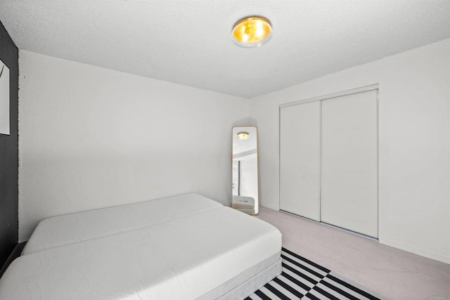 carpeted bedroom featuring a closet